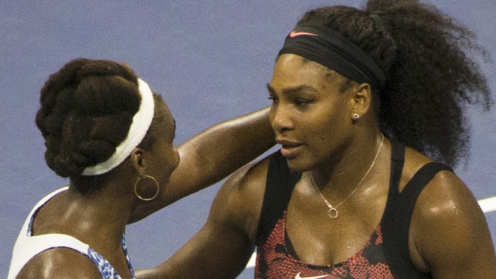 Serena Williams of the U.S. embraces her sister and compatriot Venus Williams after defeating her in their quarterfinals match at the U.S. Open Championships tennis tournament in New York