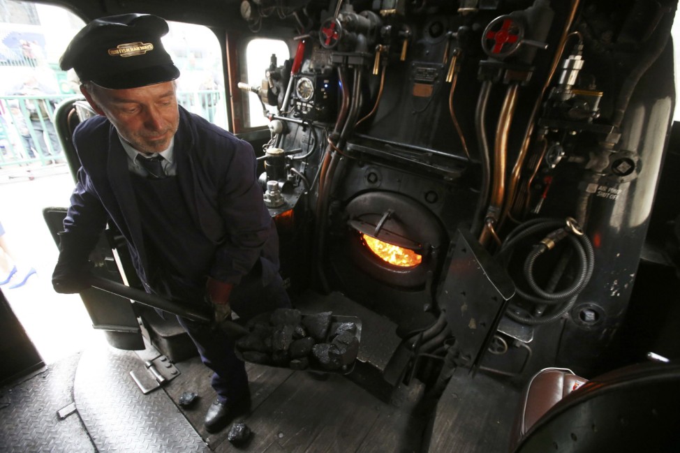 Tony Jones works in the engine of a steam train at Edinburgh's Waverley Station in Scotland