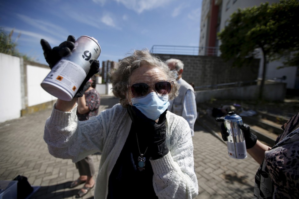 Ivone, 86, shows a spraycan during a graffiti class offered by the LATA 65 organization in Lisbon