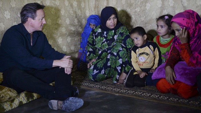 Prime Minister David Cameron meets a Syrian refugee family in a settlement camp in the Bekaa Valley in Lebanon
