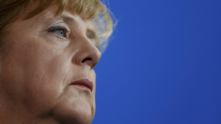 German Chancellor Merkel looks on at a news conference at the chancellery in Berlin