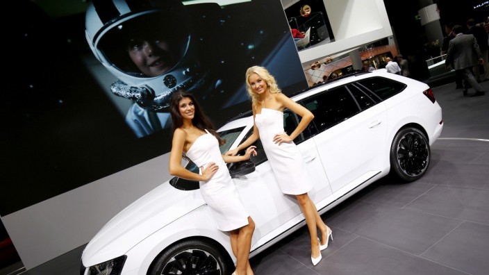 Models pose nex to a Skoda Superb during the media day at the Frankfurt Motor Show in Frankfurt