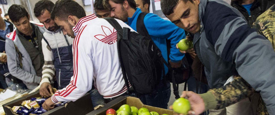 Gesetzentwurf zu Flüchtlingskrise: Jeder nur einen Apfel - als Wegzehrung für den Weg zurück? Geflohene, die gerade aus München gekommen sind, bekommen am 16. September 2015 in Berlin Essen und Getränke