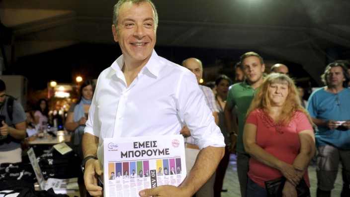 Leader of the centre-left To Potami party Theodorakis holds pre-election material before a rally in Athens