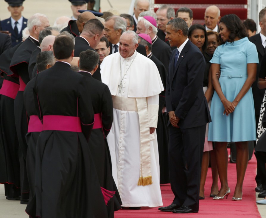 U.S. President Obama welcomes Pope Francis to the United States as the Pontiff shakes hands with dignitaries upon his arrival at Joint Base Andrews outside Washington