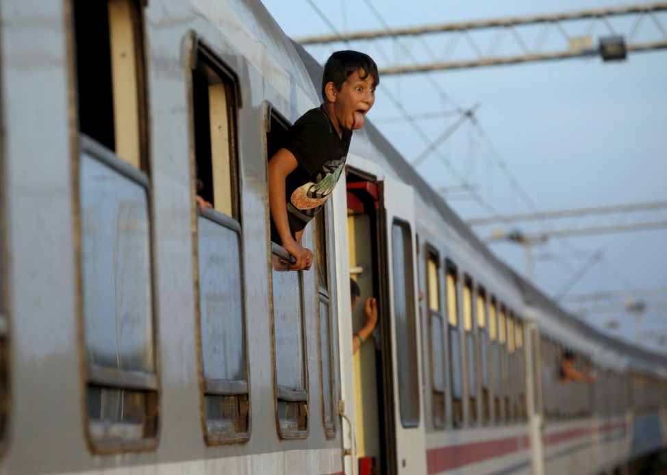 Migrant waits to depart from railway station in Tovarnik