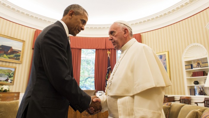 U.S. President Barack Obama greets Pope Francis during the pope's visit to the White House in Washington