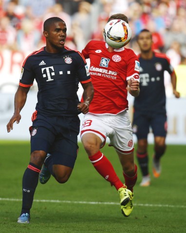 Daniel Brosinski of FSV Mainz 05 challenges Douglas Costa of FC Bayern Munich during their German first division Bundesliga soccer match in Mainz
