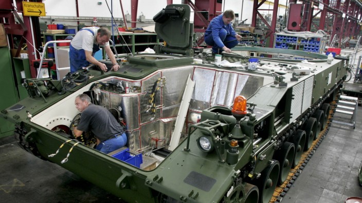 Employees work on the production line of the new PzH 2000 Ho