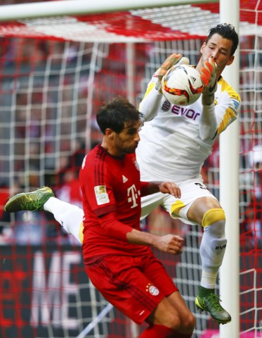 Bayern Munich's Martinez attacks Borussia Dortmund's Buerki during their German first division Bundesliga soccer match in Munich