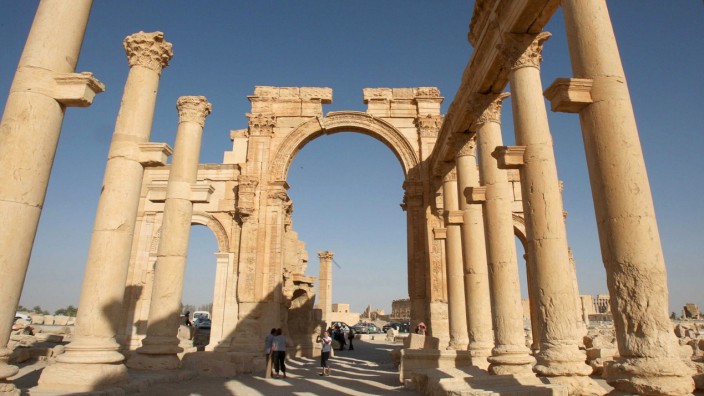Tourists walk in the historical city of Palmyra