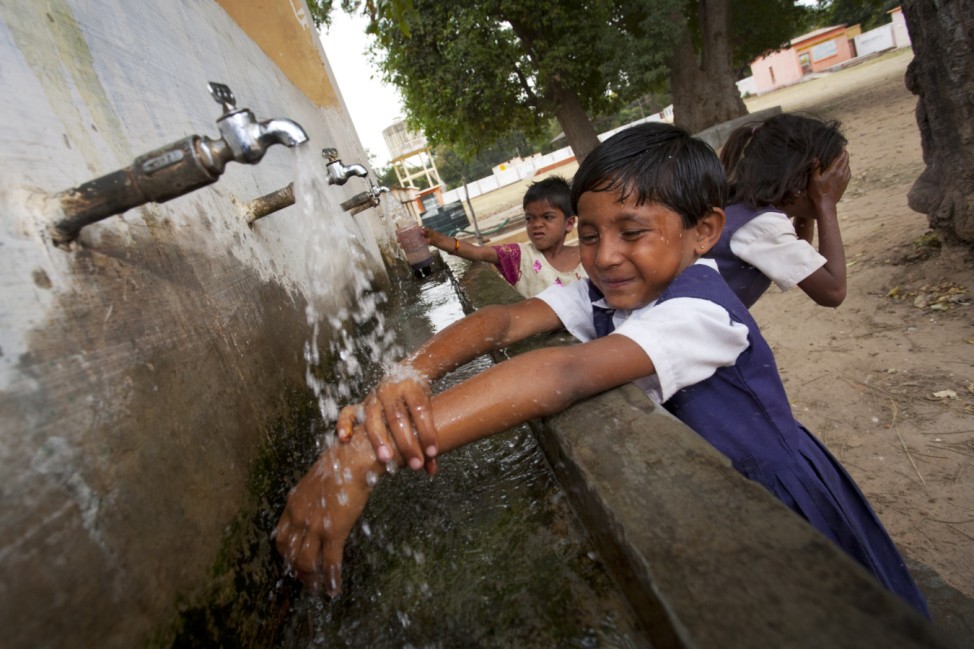 Indian schoolchildren washing at village school