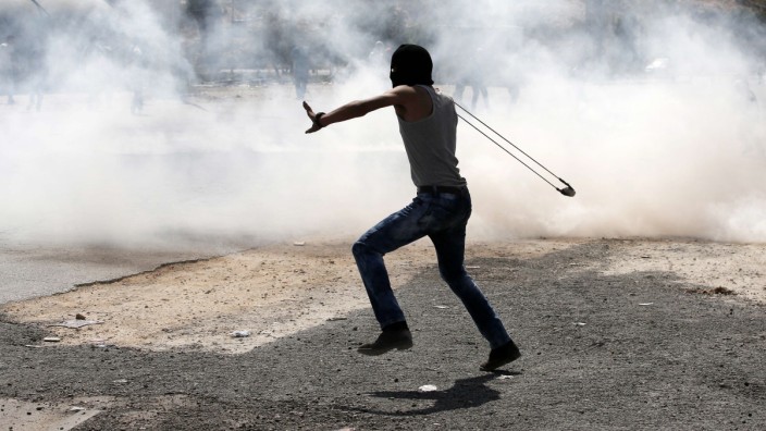 Nahostkonflikt: Steine und Schüsse: Ein palästinensischer Demonstrant in Beit El im Westjordanland benutzt eine Schleuder, um Steine auf israelische Soldaten zu werfen.