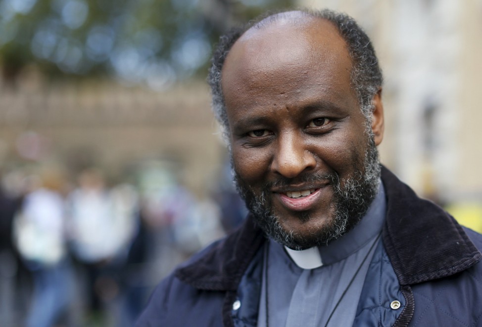 Eritrean priest Mussie Zerai smiles during an interview in front of Saint Peter's Square at the Vatican
