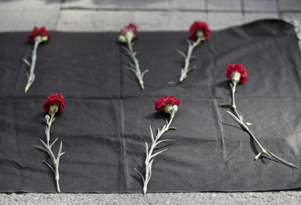 Carnations are seen placed on the ground during a protest against explosions at a peace march in Ankara, in central Istanbul
