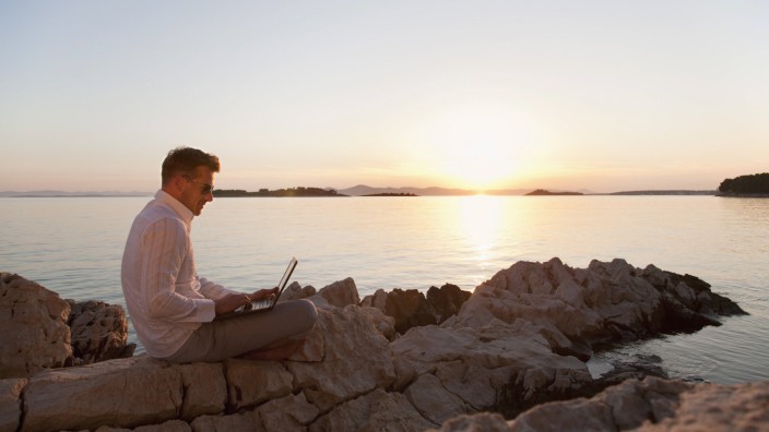 Croatia Zadar Young man using laptop on beach model released PUBLICATIONxINxGERxSUIxAUTxHUNxONLY H