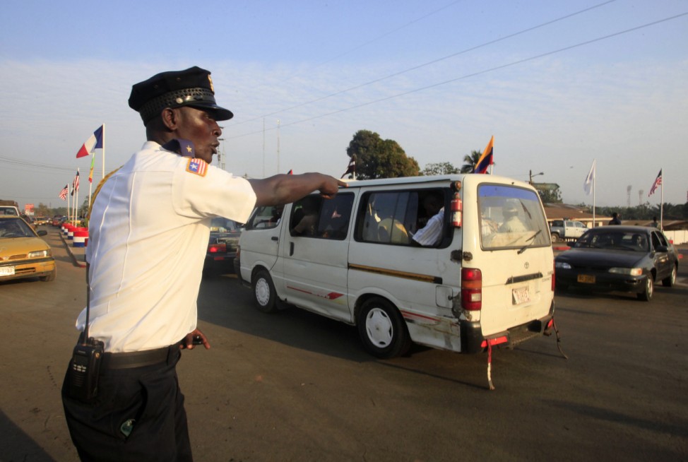 A policeman regulates traffic in Monrovia