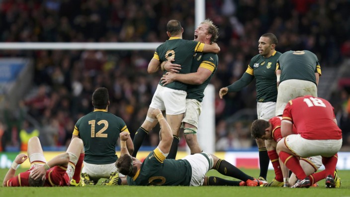 Fourie du Preez of South Africa celebrates his winning try with team mate Schalk Burger on the final whistle of their Rugby World Cup Quarter Final match against Wales at Twickenham in London