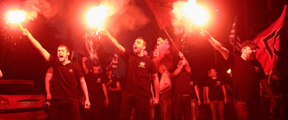 Members of extreme right party Golden Dawn celebrate holding flares in northern coastal city of Thessaloniki after Greece's general elections