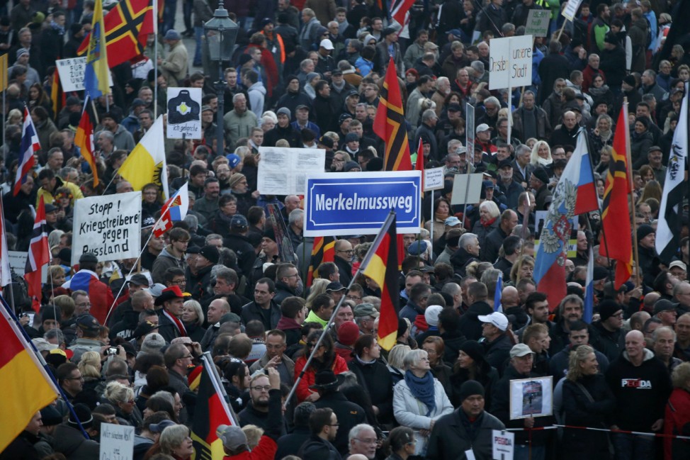 People gather for an anti-immigration demonstration organised by PEGIDA in Dresden