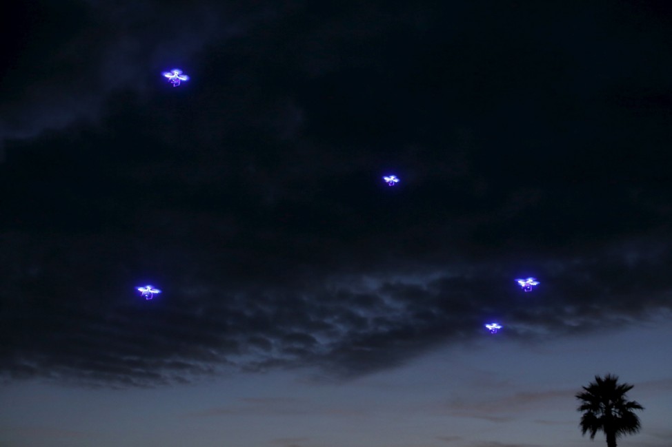 Drones fly in synchronization above attending conference goers as they dine outside along the ocean during the opening remarks at the beginning of the  Wall Street Journal Digital Live ( WSJDLive ) conference at the Montage hotline Laguna Beach