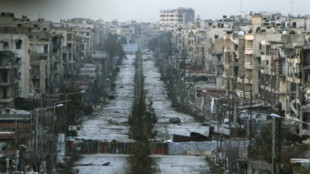 A general view shows a damaged street with sandbags used as barriers in Aleppo's Saif al-Dawla district