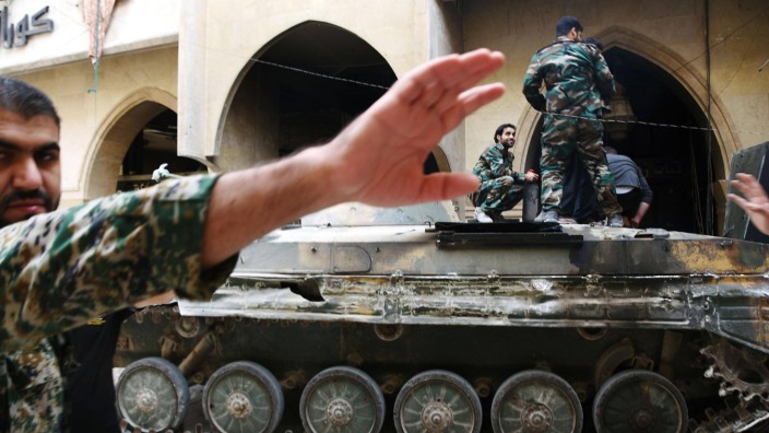 Photos from Aleppo Syria An officer front in Syrian government forces attempts to stop photos bei