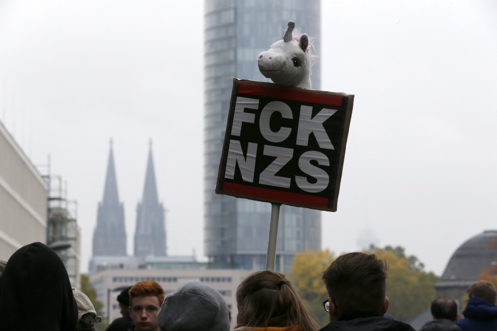 Protesters hold a banner against a neo-Nazi rally, organized by members of German far-right groups in Cologne