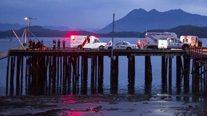 Rescue personnel mounting a search for victims of a capsized whale-watching boat park on a wharf in Tofino