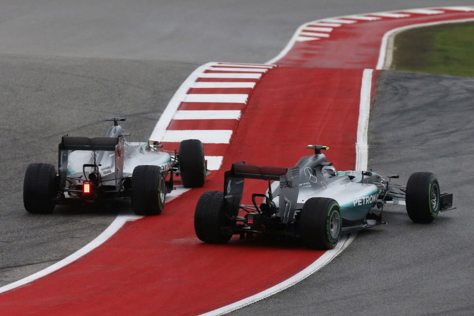 Mercedes Formula One driver Hamilton of Britain passes teammate Rosberg of Germany during the U.S. F1 Grand Prix at the Circuit of The Americas in Austin