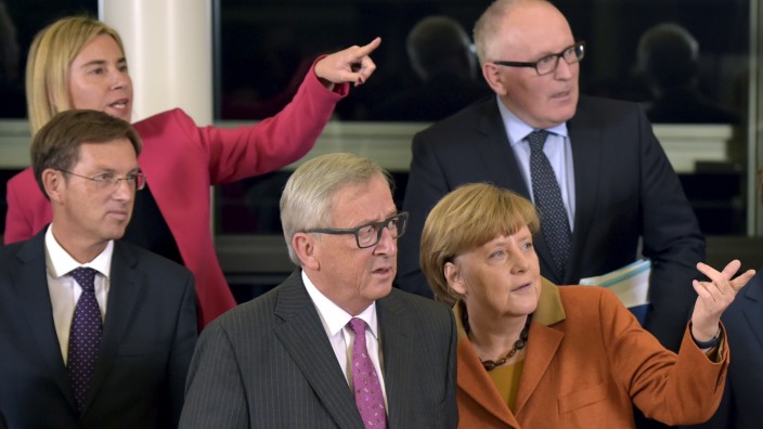EU leaders and EC President Juncker and Germany's Chancellor Merkel gesture during a family photo at a meeting over the Balkan refugee crisis with leaders from central and eastern Europe in Brussels