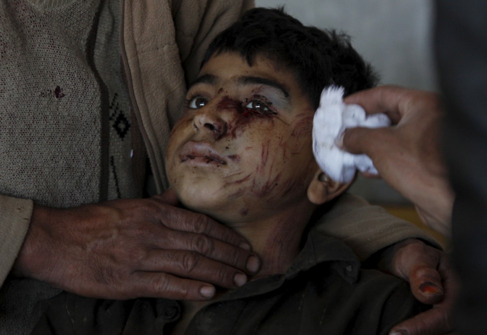 A boy, who was injured during an earthquake, receives first aid at the Lady Reading hospital in Peshawar