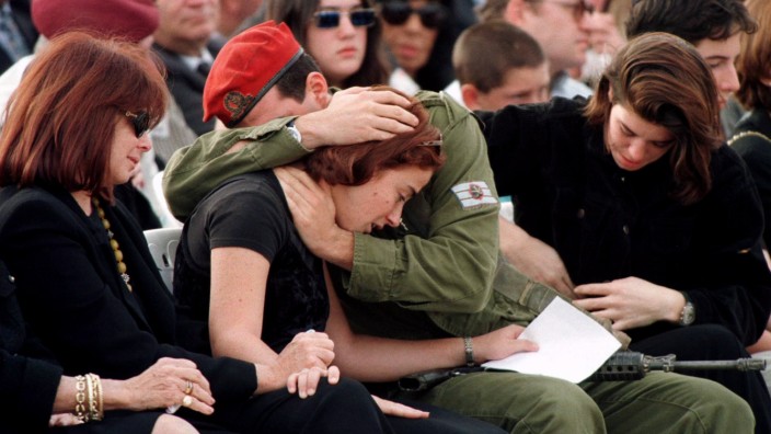 Slain Israeli Prime Minister Yitzhak Rabin's grandson Yonatan, an Israeli paratrooper, hugs his sist..