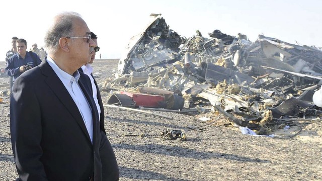 Egypt's Prime Minister Sherif Ismail looks at the remains of a Russian airliner after it crashed in central Sinai near El Arish city