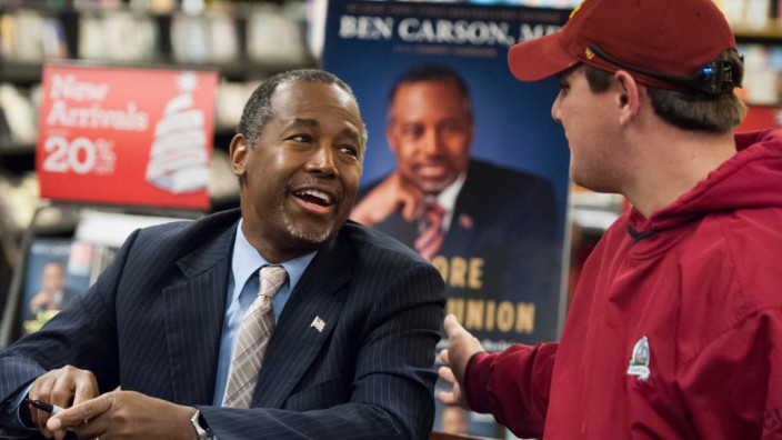 Dr. Ben Carson greets a supporter at a book tour stop in Ames, Iowa