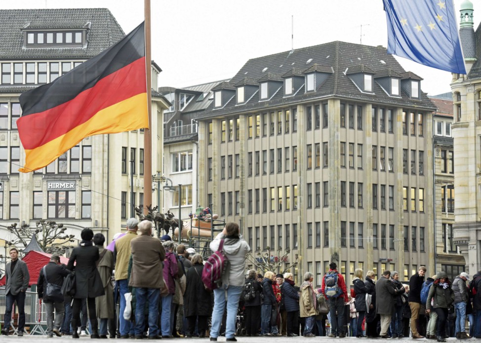 People queue to sign the book of condolences for former West German Chancellor Schmidt in front of the town hall in Hamburg