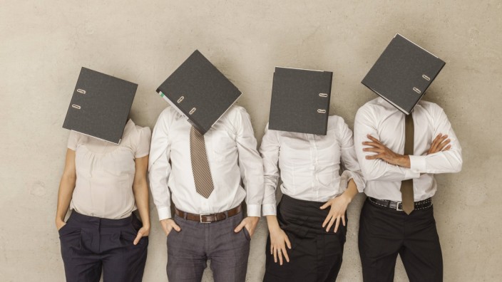 Business people with covered head by folders model released PUBLICATIONxINxGERxSUIxAUTxHUNxONLY BAEF
