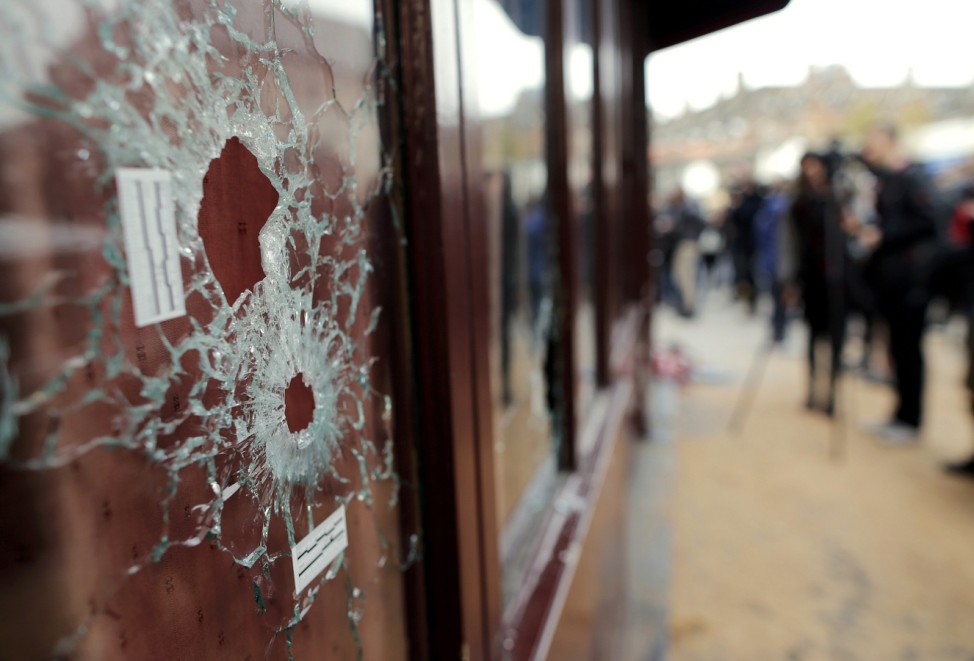 Bullet impacts are seen in the window of the Le Carillon restaurant the morning after a series of deadly attacks in Paris
