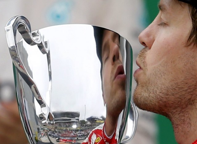 Ferrari Formula One driver Vettel of Germany kisses his third place trophy after the Brazilian F1 Grand Prix in Sao Paulo
