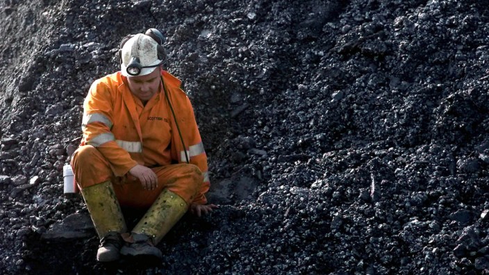 A miner at Longannet deep mine in Fife sits on a pile of coal after hearing that the mine has been p..