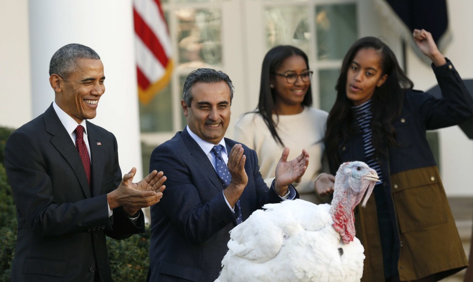 U.S. President Obama applauds after pardoning National Thanksgiving turkey Abe at White House in Washington