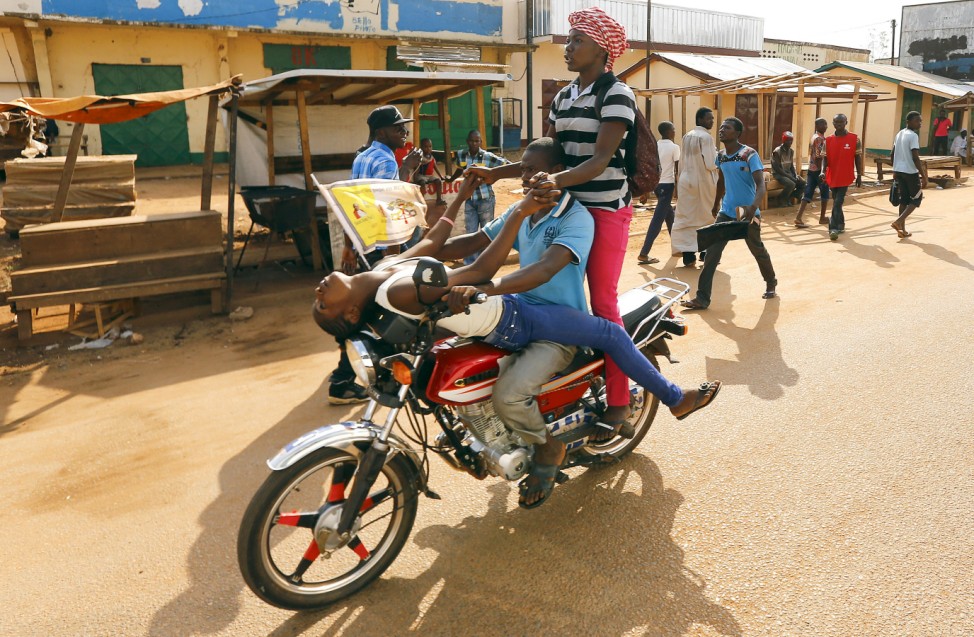 People ride a motorcycle near Koudoukou Mosque where Pope Francis meets with the Imam Tidiani Moussa Naibi in Bangui, Central African Republic
