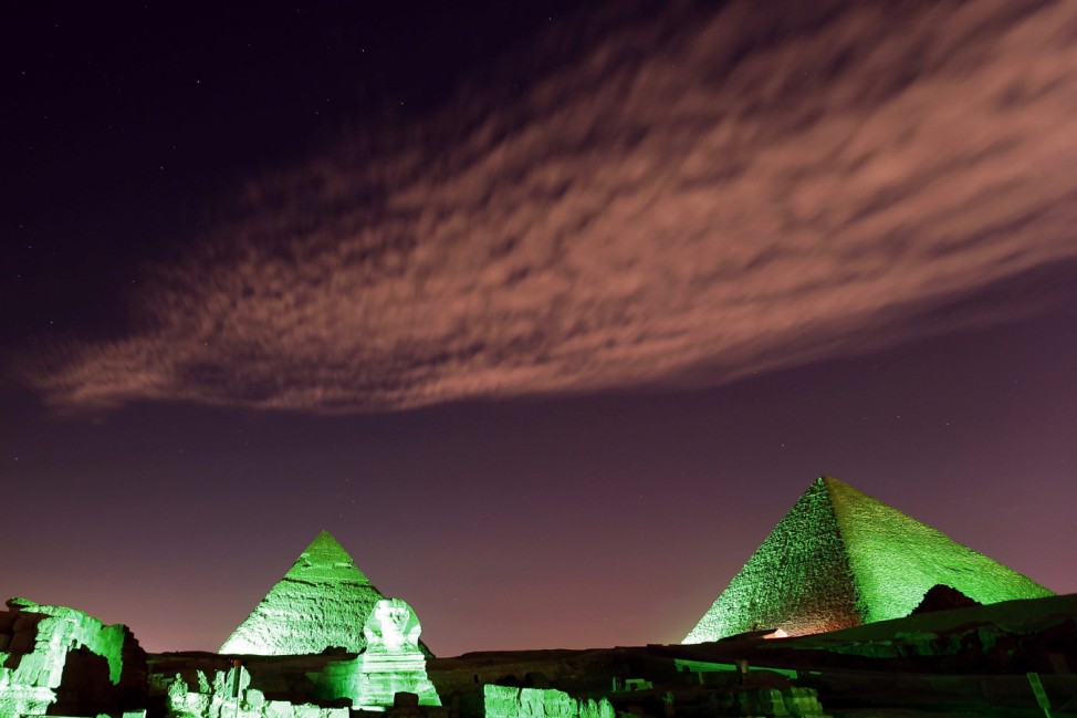 The Great Pyramids and Sphinx lit in green light