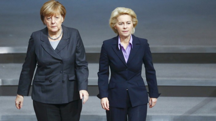 German Chancellor Merkel and Defence Minister von der Leyen walk during a session of the Bundestag, the German lower house of parliament, in Berlin