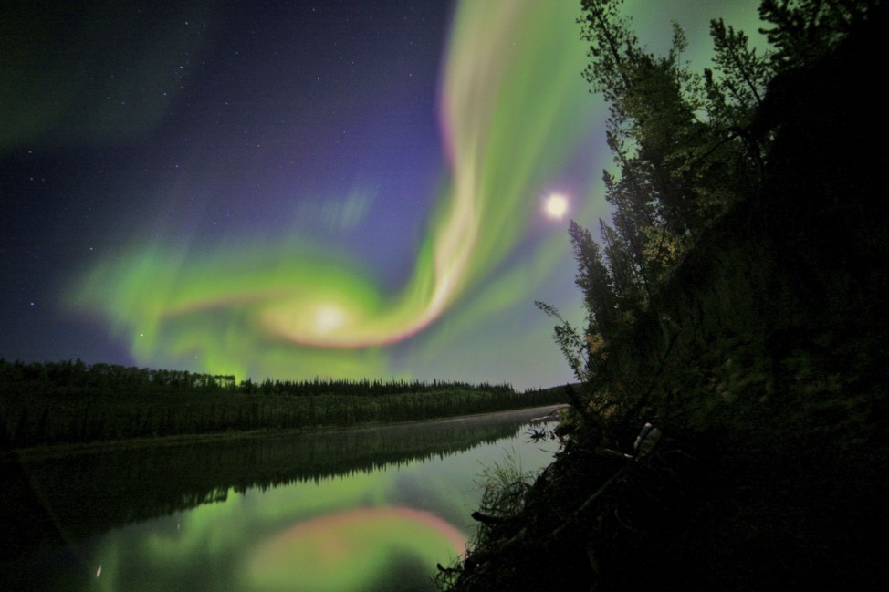 Swirls of green and red appear in an aurora over Whitehorse, Yukon