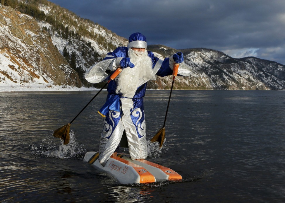Vasilyev, dressed as Father Frost, Russian equivalent of Santa Claus, water-skis along the Yenisei River outside Siberian city of Krasnoyarsk