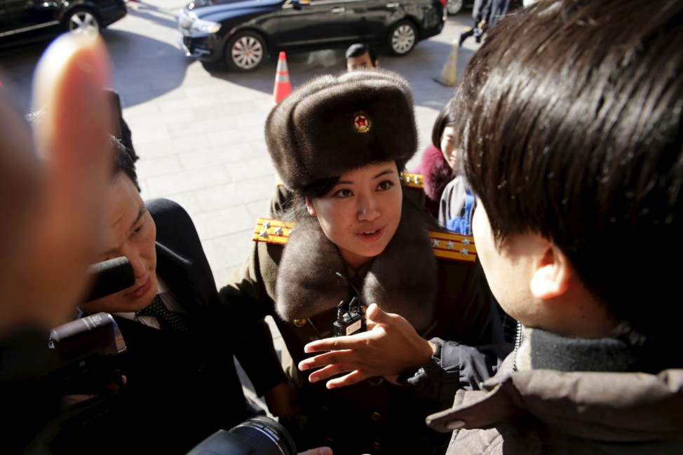 A member of the Moranbong Band from North Korea speaks to the press outside a hotel in central Beijing