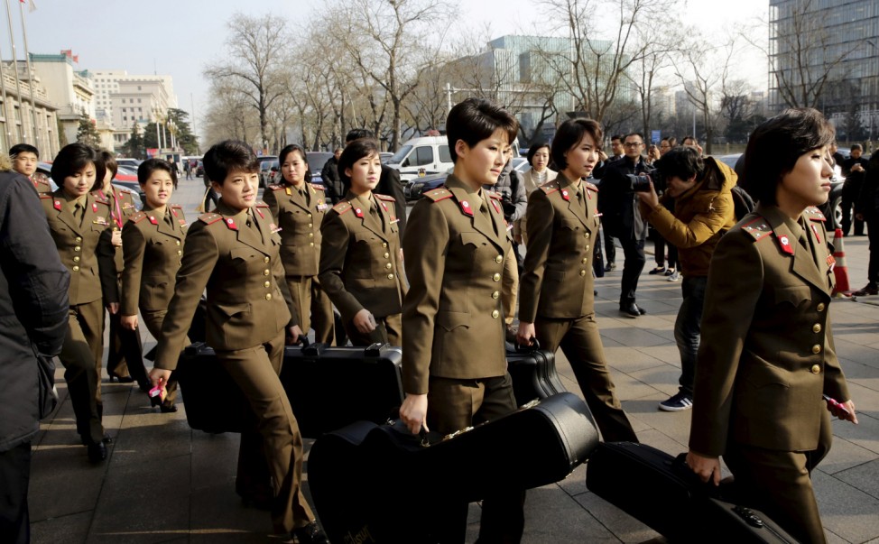 Members of the Moranbong Band from North Korea carry their instruments as they leave a hotel in central Beijing