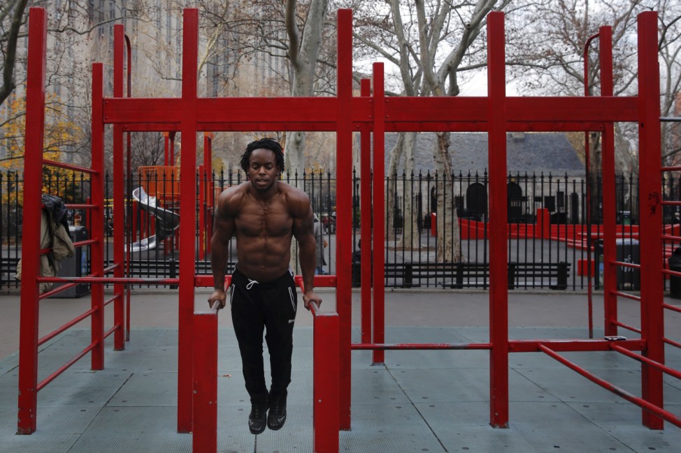 A man exercises in a park during a bout of unseasonably warm weather in the Manhattan borough of New York
