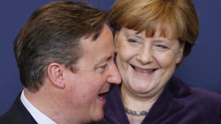 Britain's PM Cameron and Germany's Chancellor Merkel pose for a family photo during a EU leaders summit in Brussels